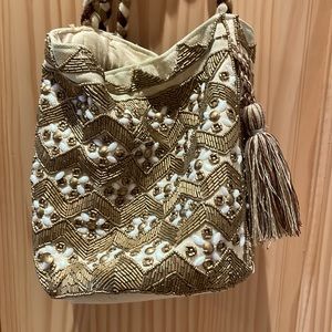 Sam Edelman beaded gold and tan bucket purse with tassels.